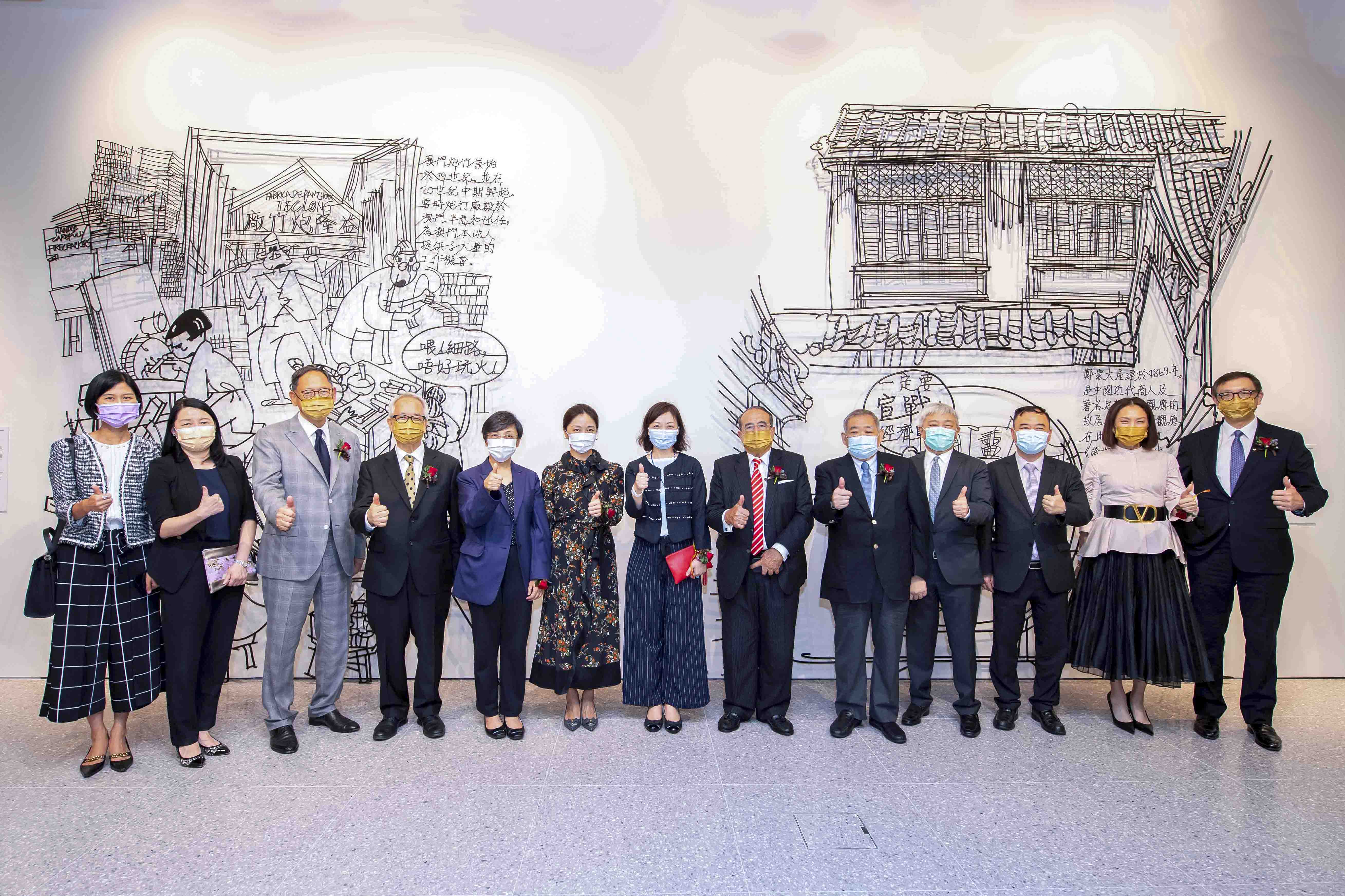 Officiating and distinguished guests took a group photo in front of the exhibits of  “Juxtapose”